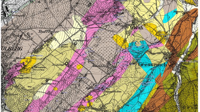 Eine historische geologische Karte mit verschiedenen Farben, die verschiedene Gesteinsarten darstellen. Die Karte zeigt auch geografische Namen und Linien, die das Terrain markieren.