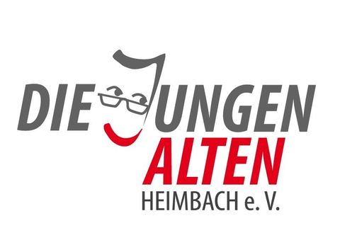 Een logo met de tekst "DIE JUNGEN ALTEN HEIMBACH e. V." in verschillende kleuren. Het toont een glimlachend gezicht met een bril.