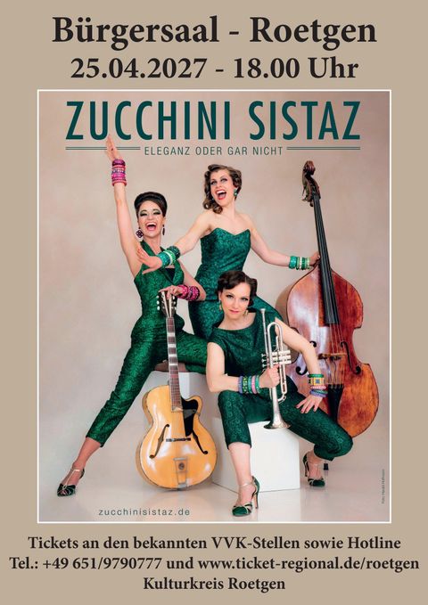 A joyful band with three female musicians in shiny green outfits.
They are posing with musical instruments in an inviting atmosphere.