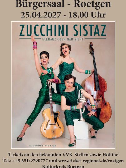 A joyful band with three female musicians in shiny green outfits.
They are posing with musical instruments in an inviting atmosphere.